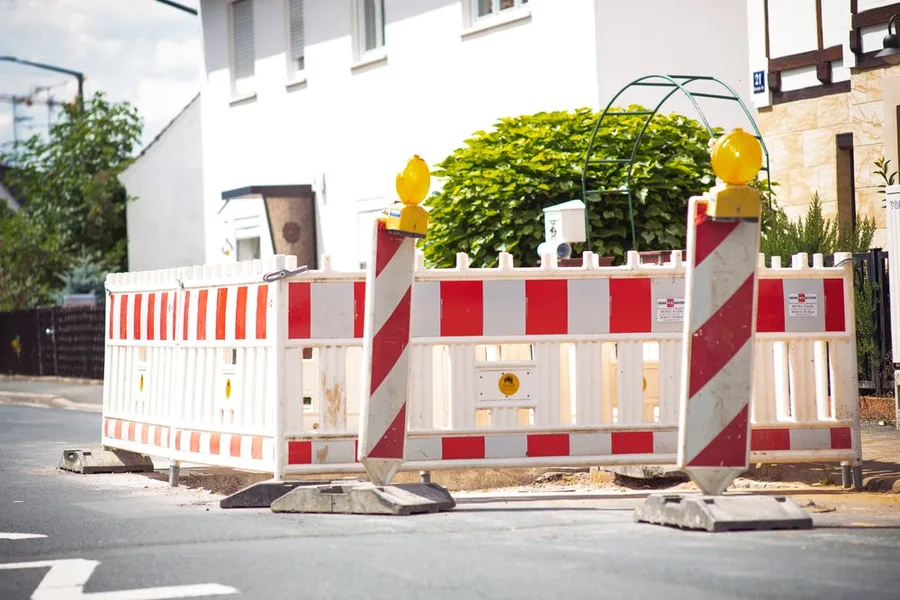 Red and white barricades along a street